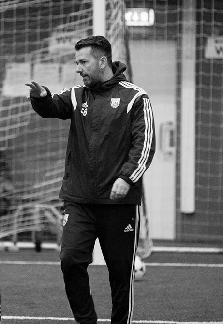 Russell Rusty Hullett coaching on an indoor football pitch