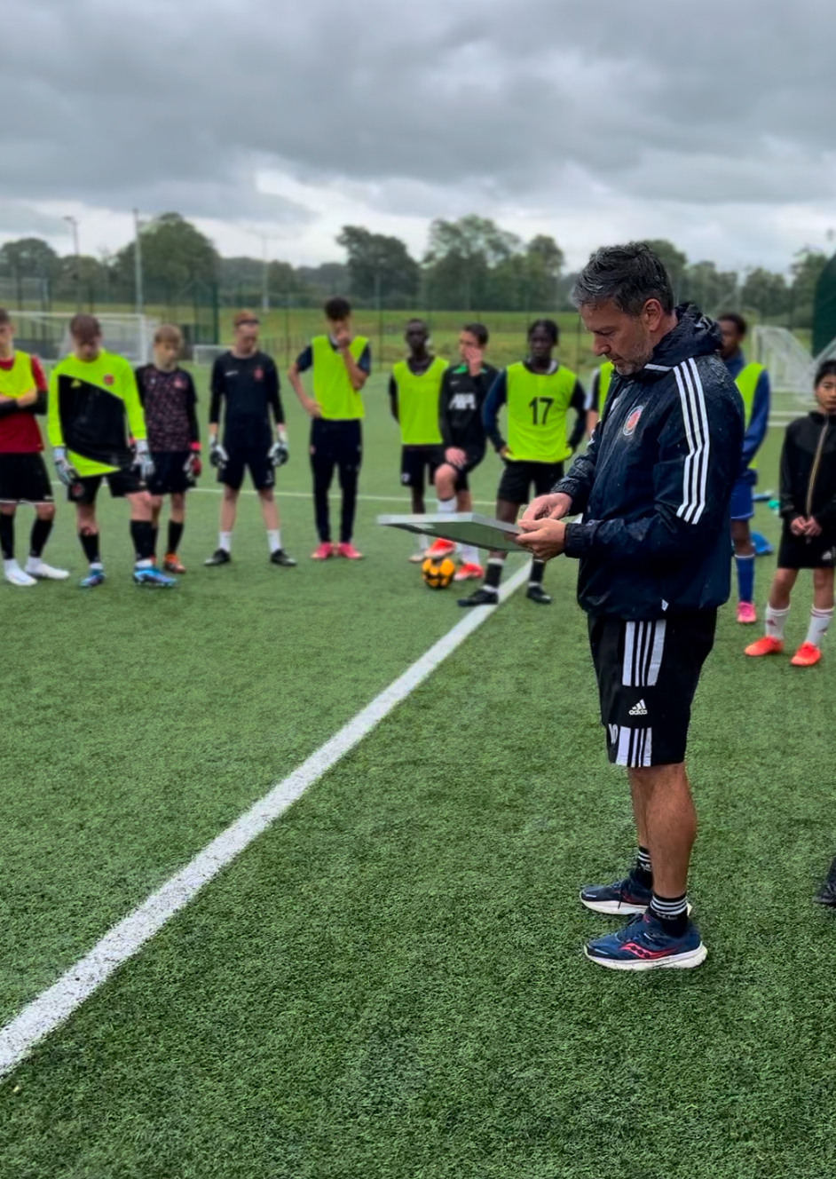 Rusty assessing Academy Insider players during a training session
